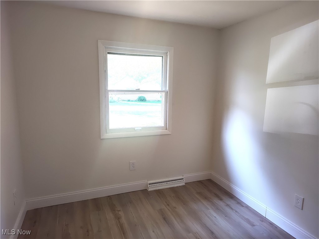 8016 Ninevah Road Geneva, OH 44041 - Photo 35 of 45 Spare room featuring baseboards and light wood-style floors