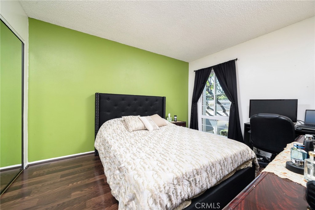 1800 West Gramercy Avenue, Unit 43 Anaheim, CA 92801 - Photo 17 of 34 a bedroom with a bed and a flat screen tv