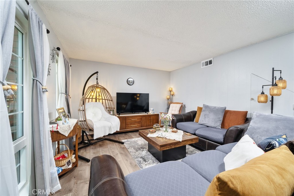 1800 West Gramercy Avenue, Unit 43 Anaheim, CA 92801 - Photo 7 of 34 a living room with furniture and a fireplace