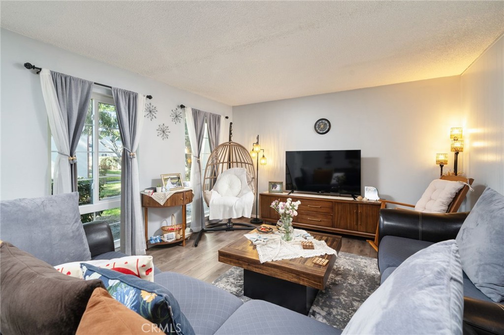 1800 West Gramercy Avenue, Unit 43 Anaheim, CA 92801 - Photo 8 of 34 a living room with furniture and a flat screen tv