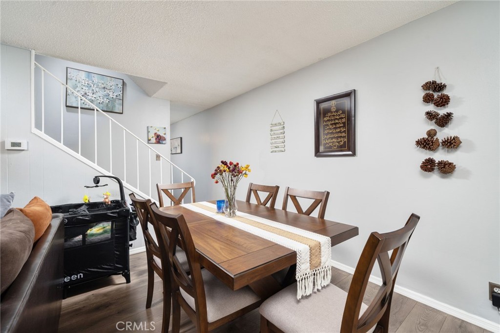 1800 West Gramercy Avenue, Unit 43 Anaheim, CA 92801 - Photo 9 of 34 a view of a dining room with furniture and wooden floor