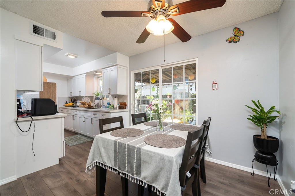 1800 West Gramercy Avenue, Unit 43 Anaheim, CA 92801 - Photo 10 of 34 a kitchen with a table chairs a microwave and cabinets
