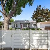 a front view of a house with a tree