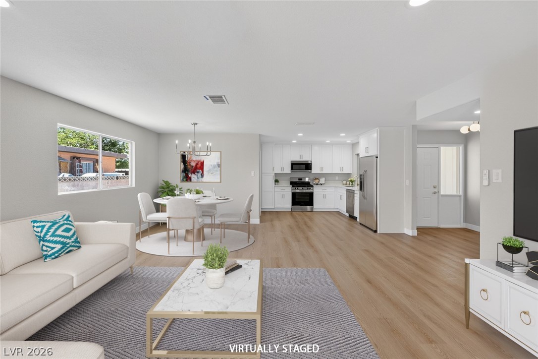 2484 Anglia Street Las Vegas, NV 89142 - Photo 3 of 20 This light-filled living space offers seamless transitions and stylish, durable flooring throughout.