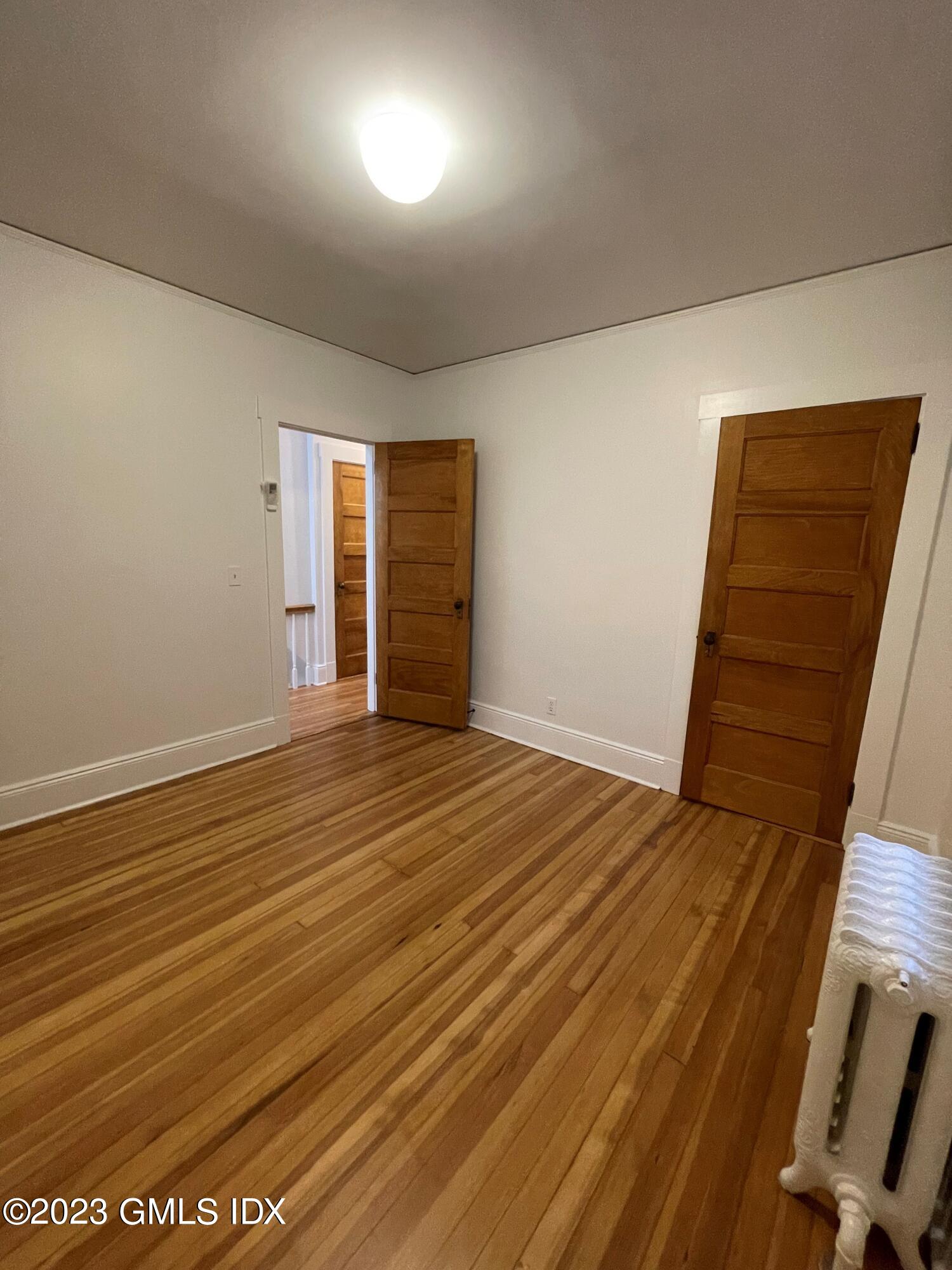 72 Prospect Street Greenwich, CT 06830 - Photo 11 of 18 an empty room with wooden floor and windows