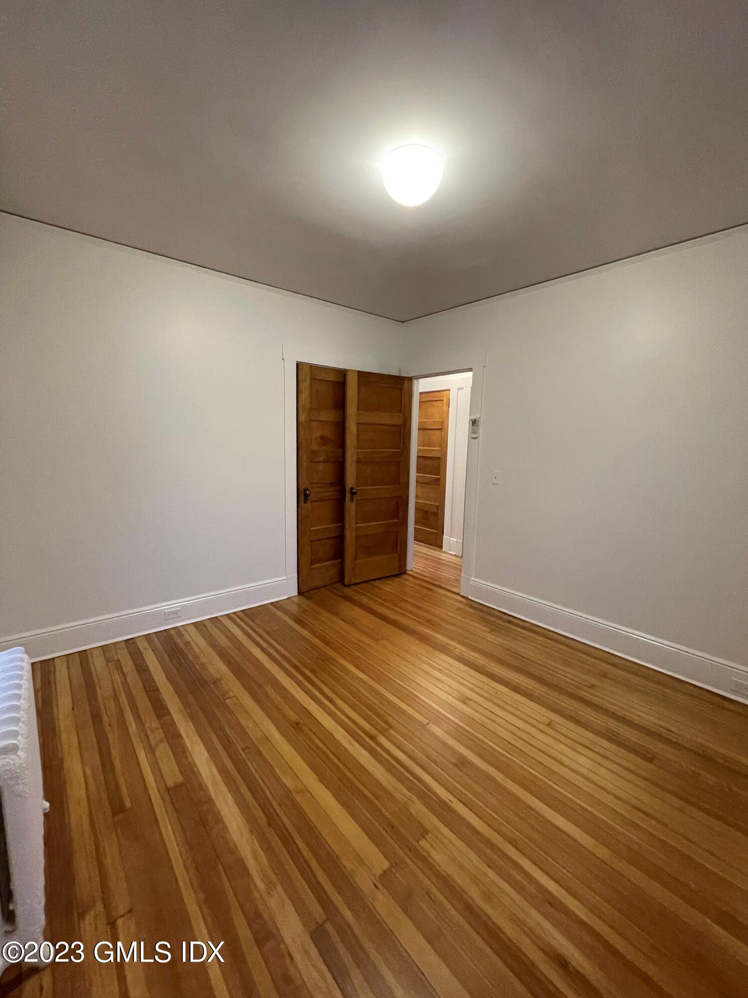72 Prospect Street Greenwich, CT 06830 - Photo 12 of 18 a view of an empty room with wooden floor and closet