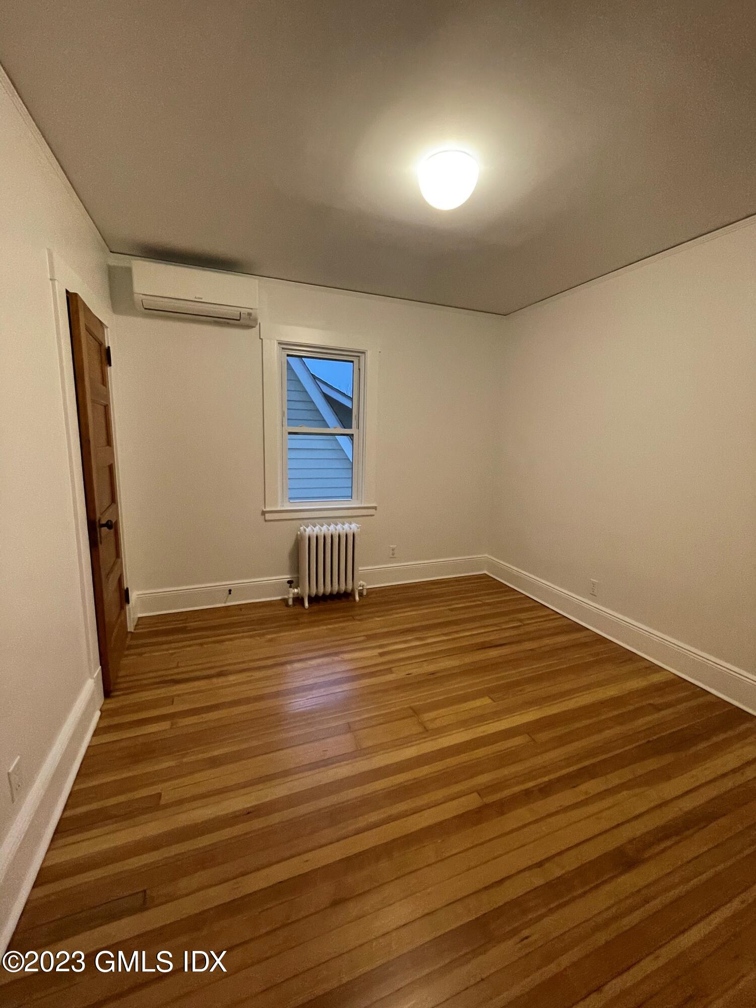72 Prospect Street Greenwich, CT 06830 - Photo 13 of 18 an empty room with wooden floor and windows