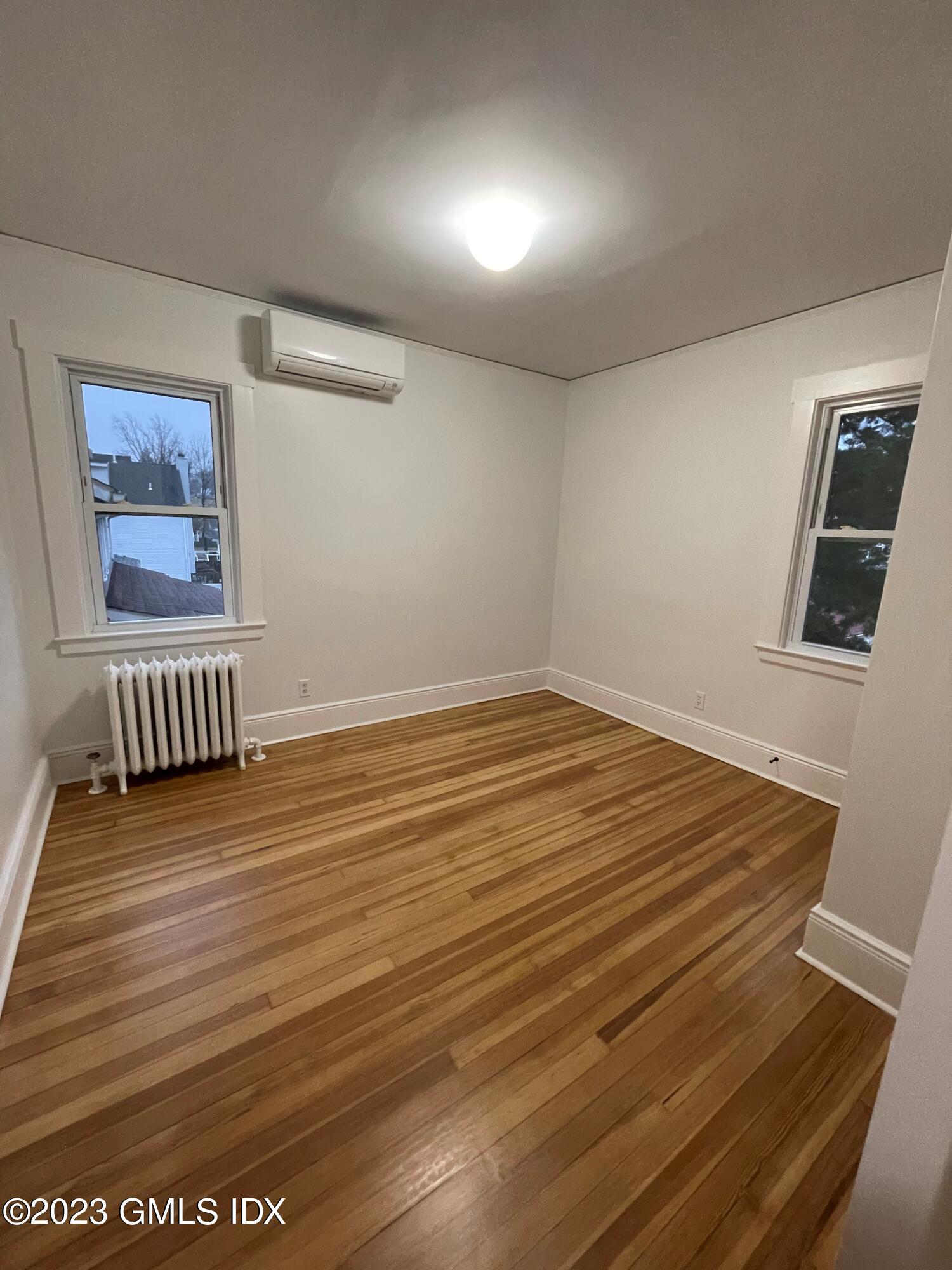 72 Prospect Street Greenwich, CT 06830 - Photo 14 of 18 a view of an empty room with wooden floor and a window