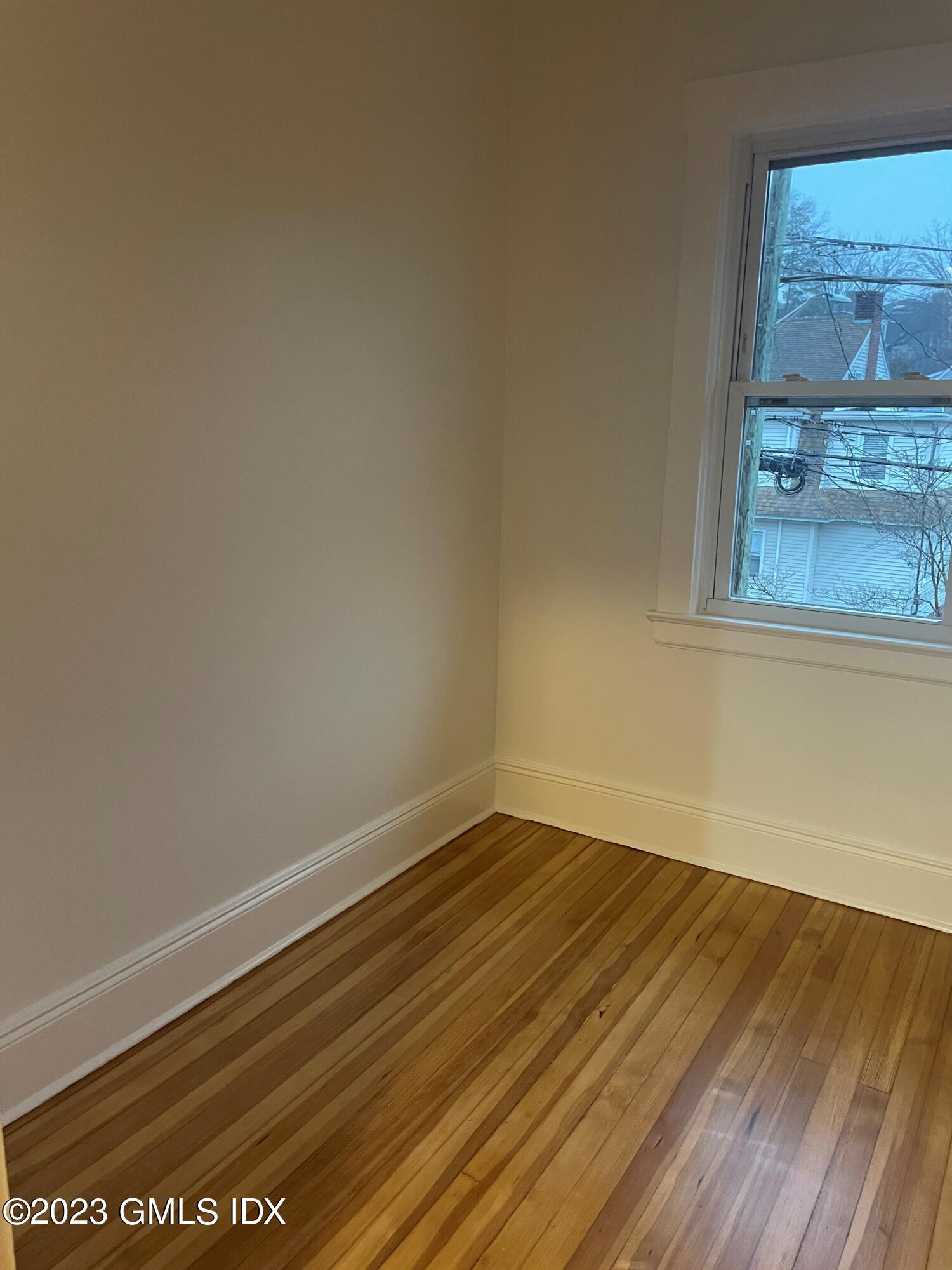 72 Prospect Street Greenwich, CT 06830 - Photo 15 of 18 a view of a room with wooden floor and a window