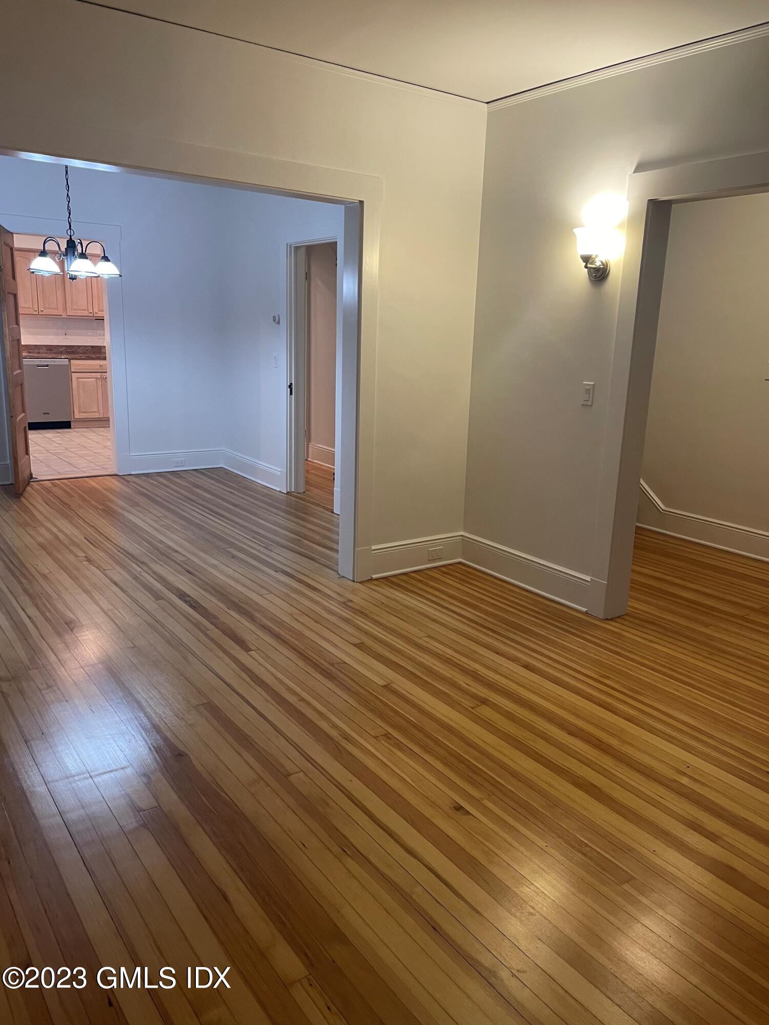 72 Prospect Street Greenwich, CT 06830 - Photo 4 of 18 an empty room with wooden floor and bathroom