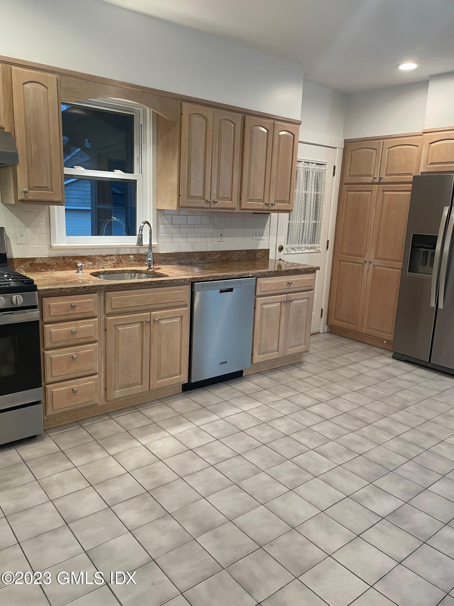 72 Prospect Street Greenwich, CT 06830 - Photo 6 of 18 a kitchen with stainless steel appliances granite countertop a sink and a stove