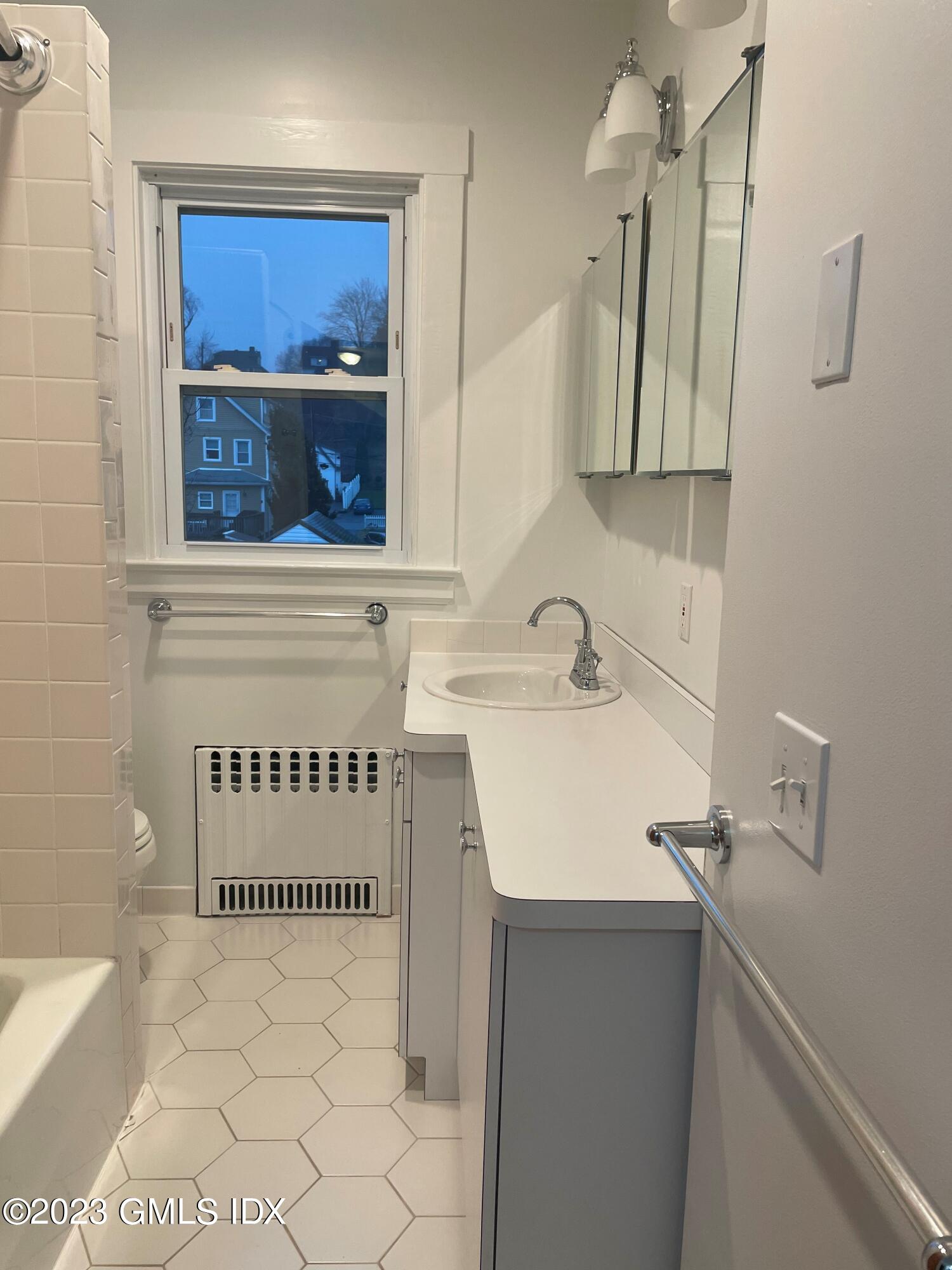 72 Prospect Street Greenwich, CT 06830 - Photo 9 of 18 a bathroom with a sink a vanity and a mirror