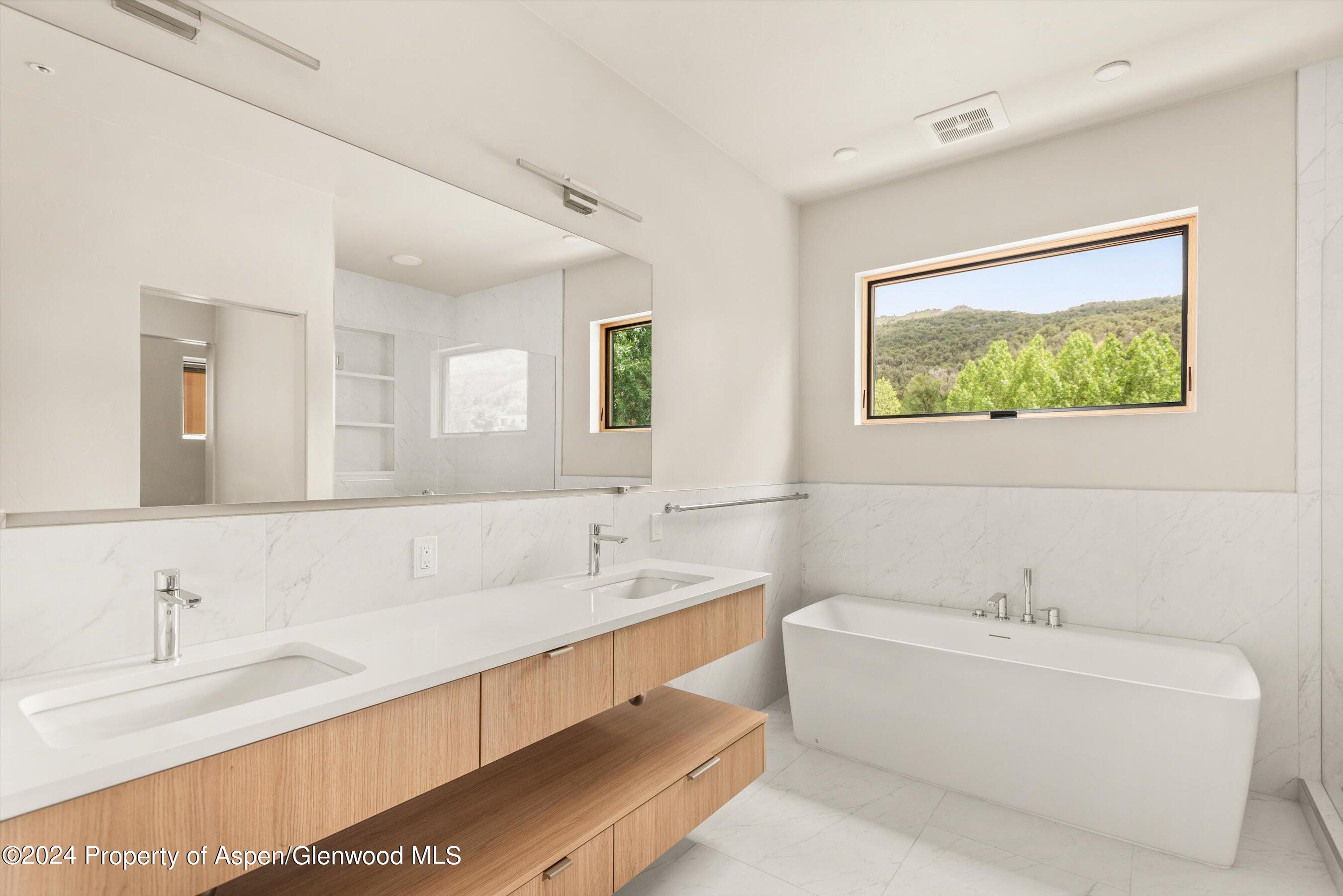 112 Valley Court Basalt, CO 81621 - Photo 26 of 37 a bathroom with a tub double sink and mirror