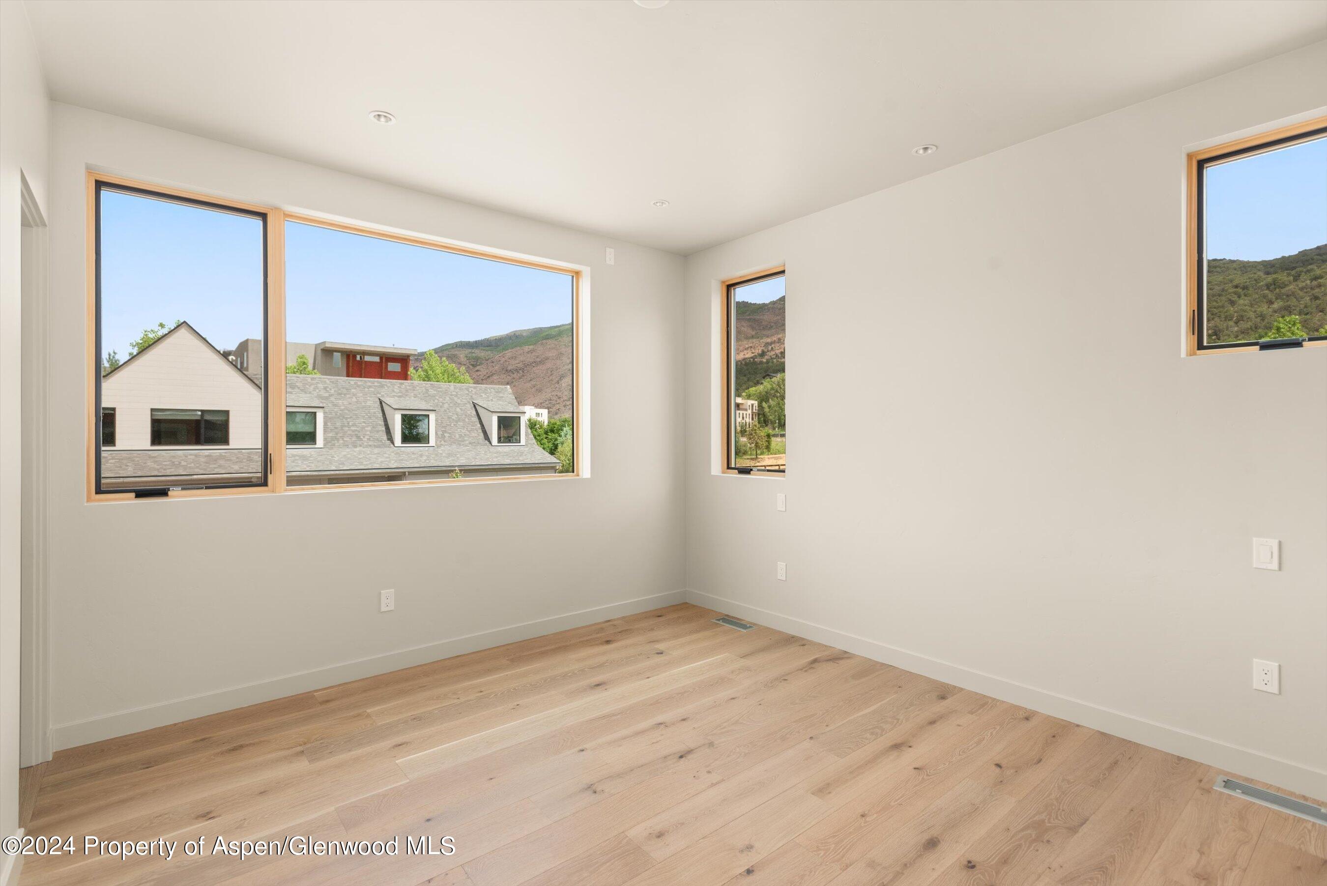 112 Valley Court Basalt, CO 81621 - Photo 30 of 37 a view of a bedroom with wooden floor and a window