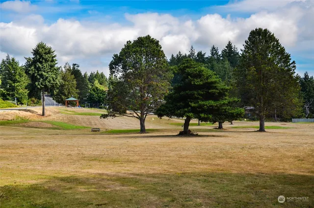 a view of a house with a porch and garden
