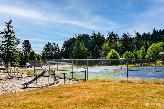 a view of a swimming pool with a patio and a garden