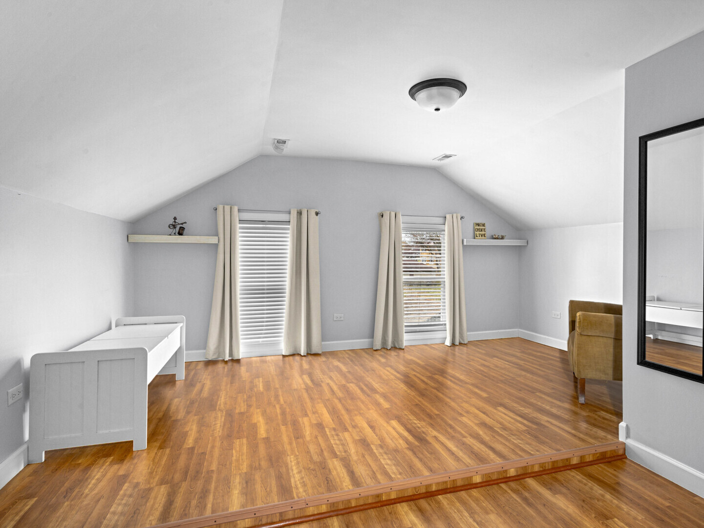 506 Oneida Street Joliet, IL 60435 - Photo 20 of 40 a spacious bedroom with a bed and wooden floor