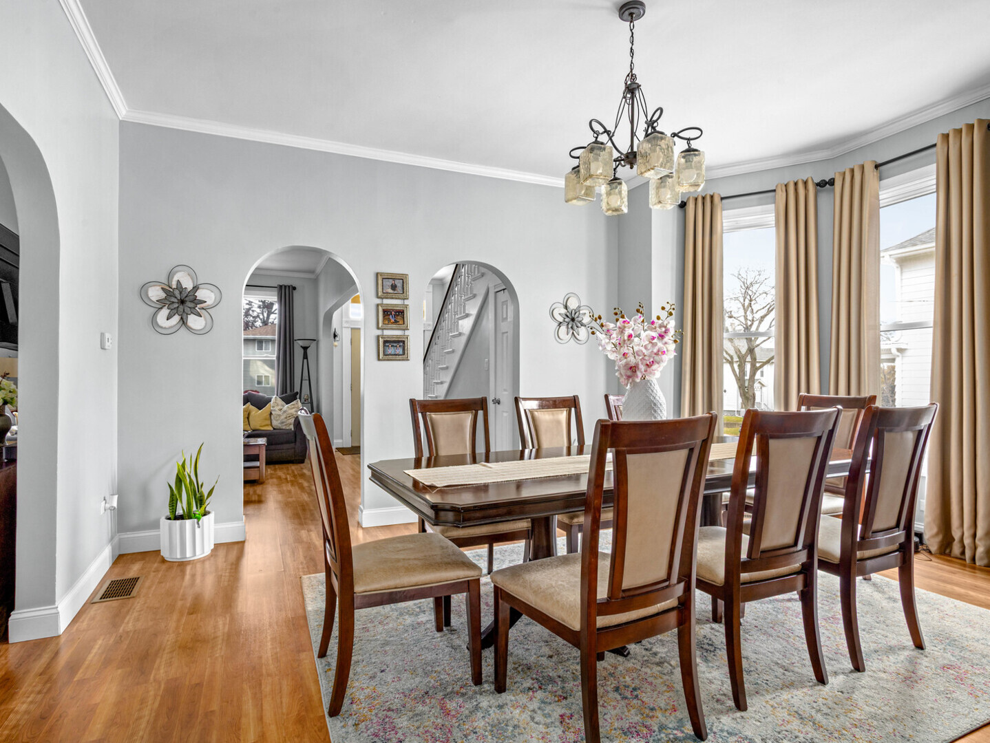 506 Oneida Street Joliet, IL 60435 - Photo 22 of 40 a view of a dining room with furniture a chandelier and wooden floor