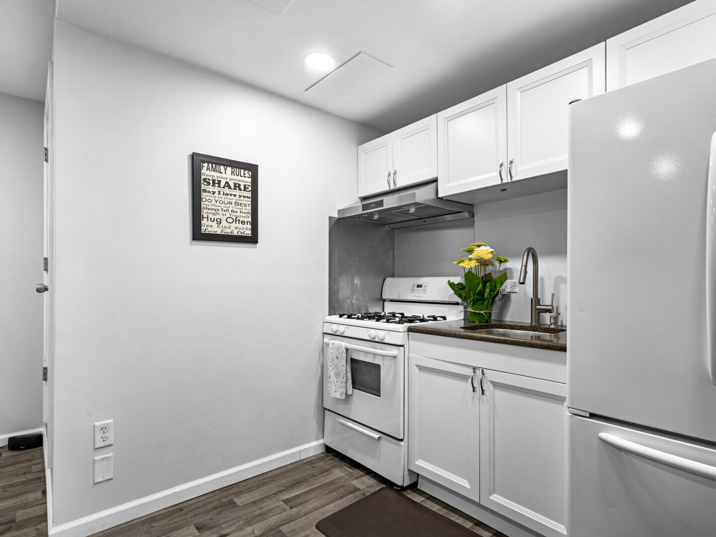 506 Oneida Street Joliet, IL 60435 - Photo 27 of 40 a kitchen with white cabinets and white appliances