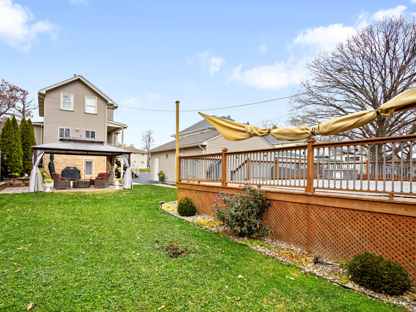 506 Oneida Street Joliet, IL 60435 - Photo 7 of 40 a view of a house with a big yard and large trees