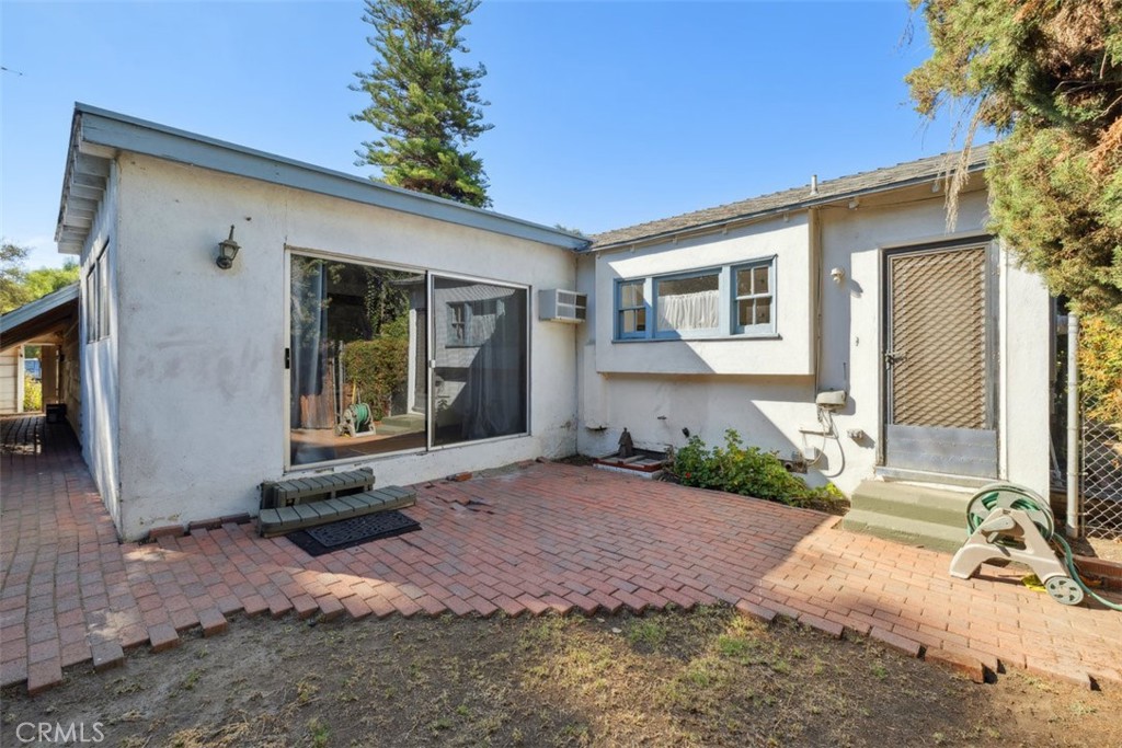 23265 Leonora Drive Woodland Hills, CA 91367 - Photo 1 of 3 a front view of a house with garden