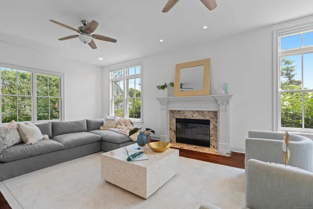 a living room with furniture and a fireplace