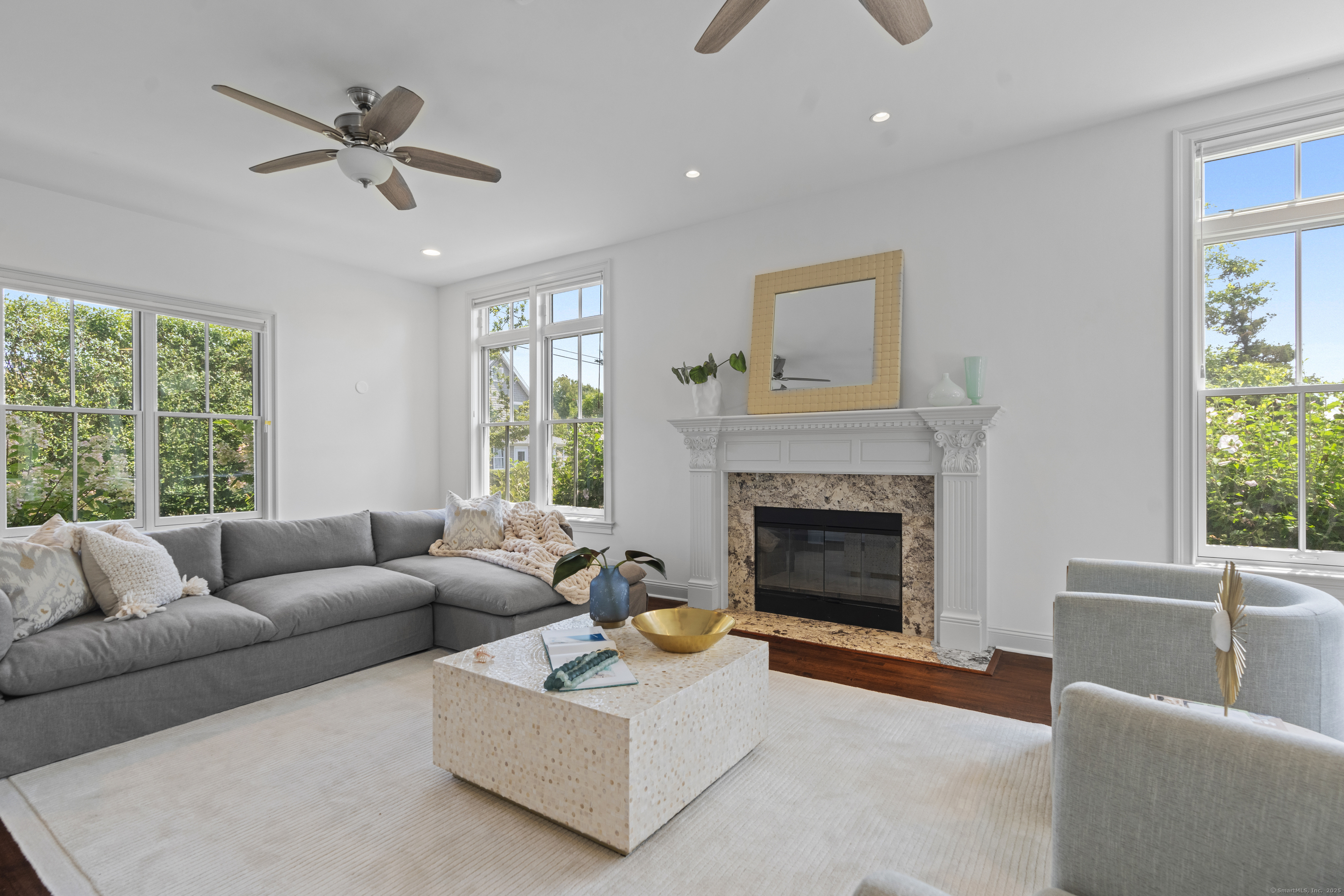 64 Webster Point Road Madison, CT 06443 - Photo 11 of 38 a living room with furniture and a fireplace