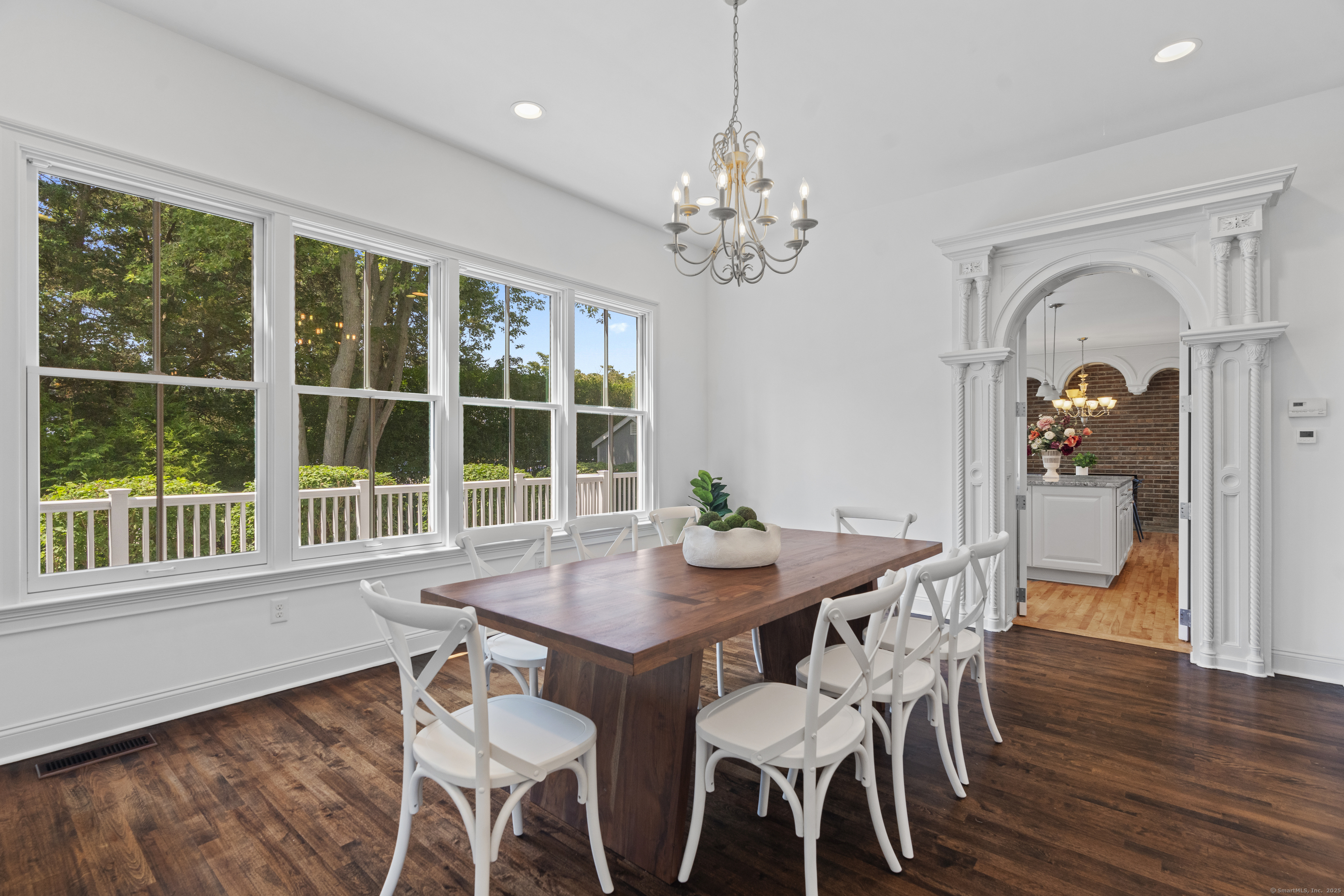 64 Webster Point Road Madison, CT 06443 - Photo 14 of 38 a view of a dining room with furniture window and wooden floor