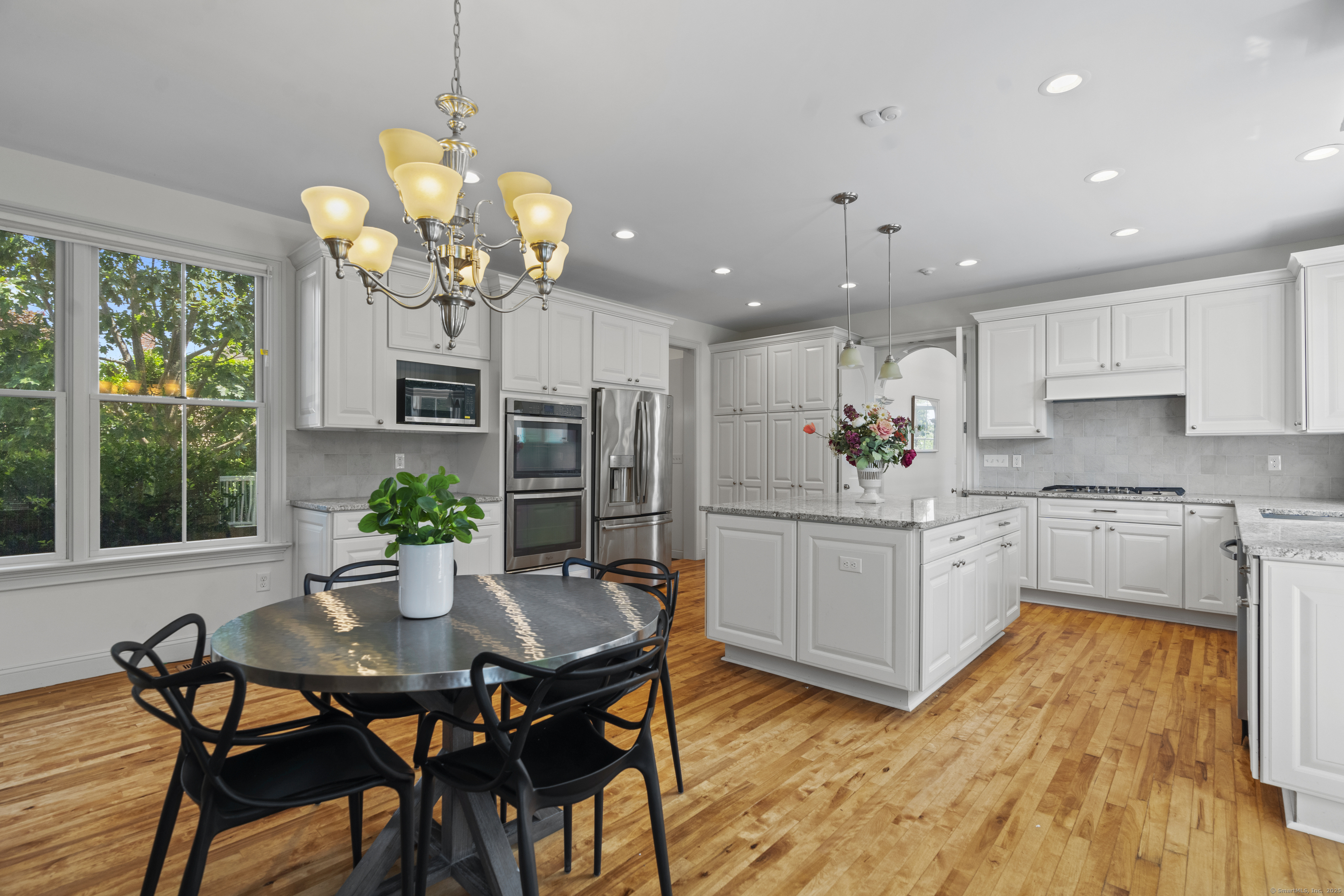 64 Webster Point Road Madison, CT 06443 - Photo 19 of 38 a kitchen with a table and chairs in it