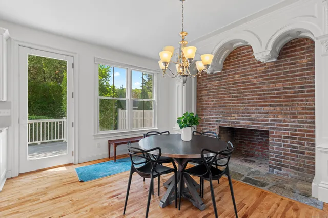 a view of a dining room with furniture wooden floor and chandelier
