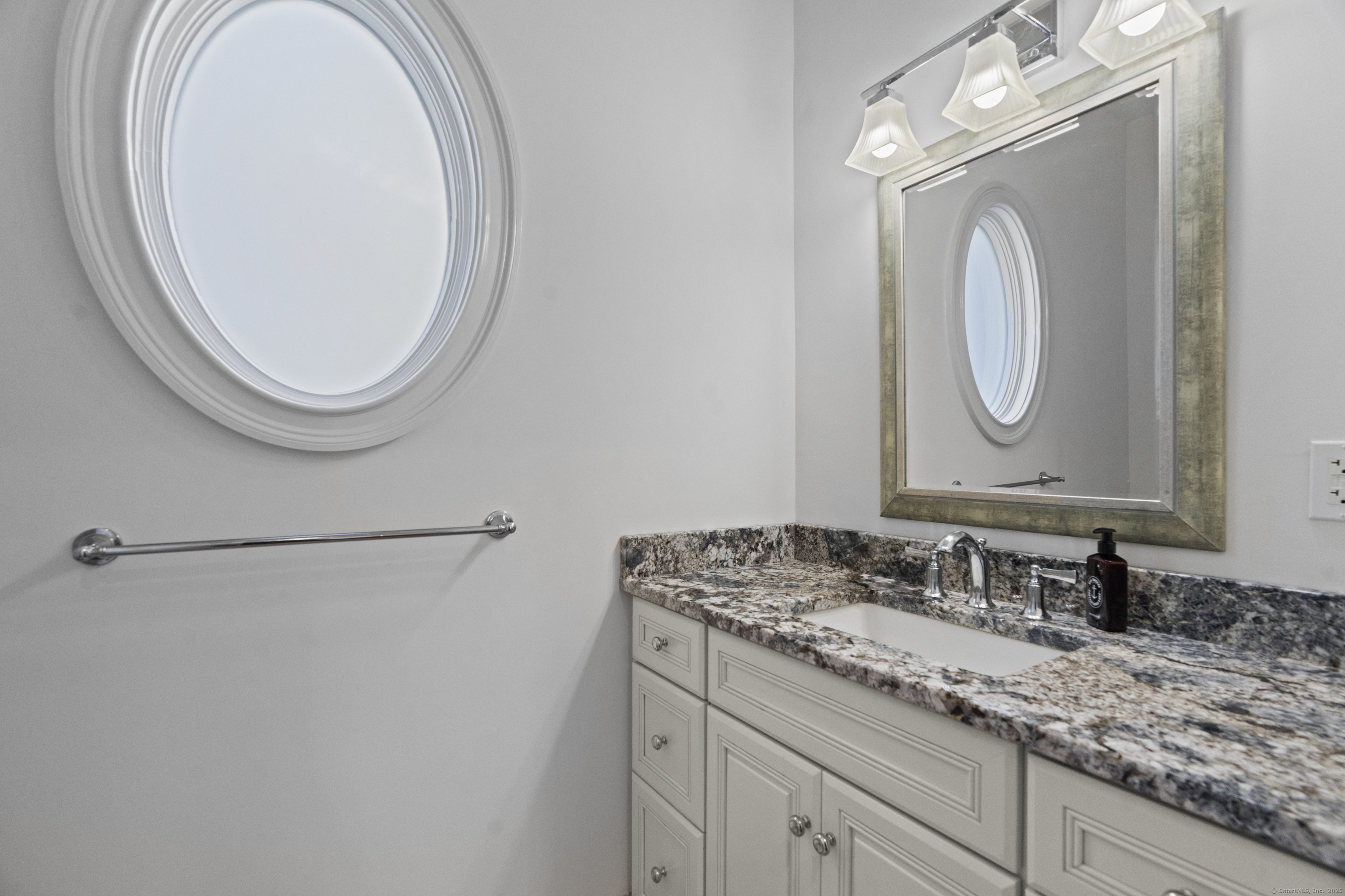 64 Webster Point Road Madison, CT 06443 - Photo 21 of 38 a bathroom with a granite countertop double vanity sink and a mirror