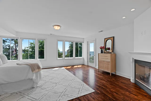 a large bedroom with a bed and wooden floor