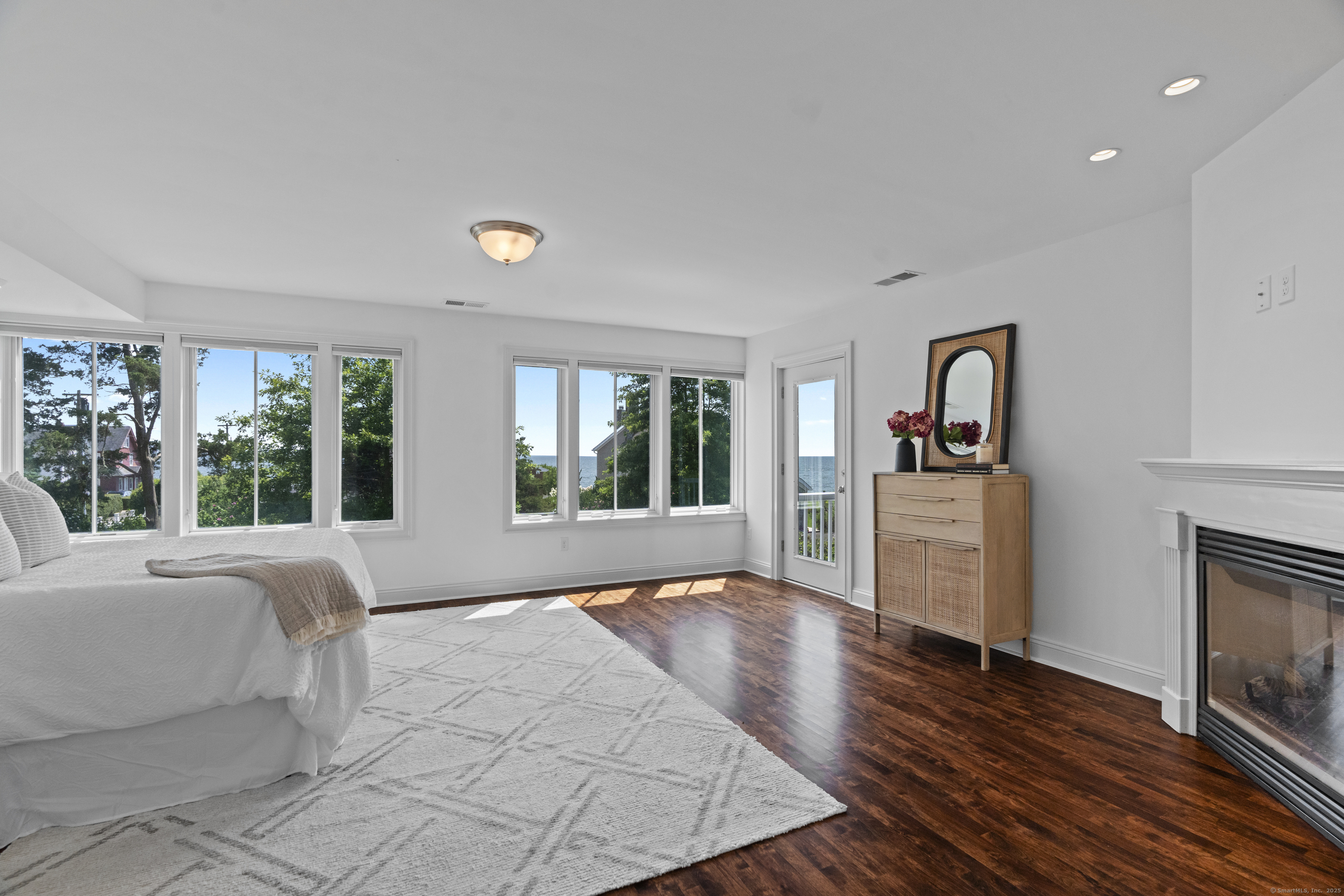 64 Webster Point Road Madison, CT 06443 - Photo 23 of 38 a large bedroom with a bed and wooden floor