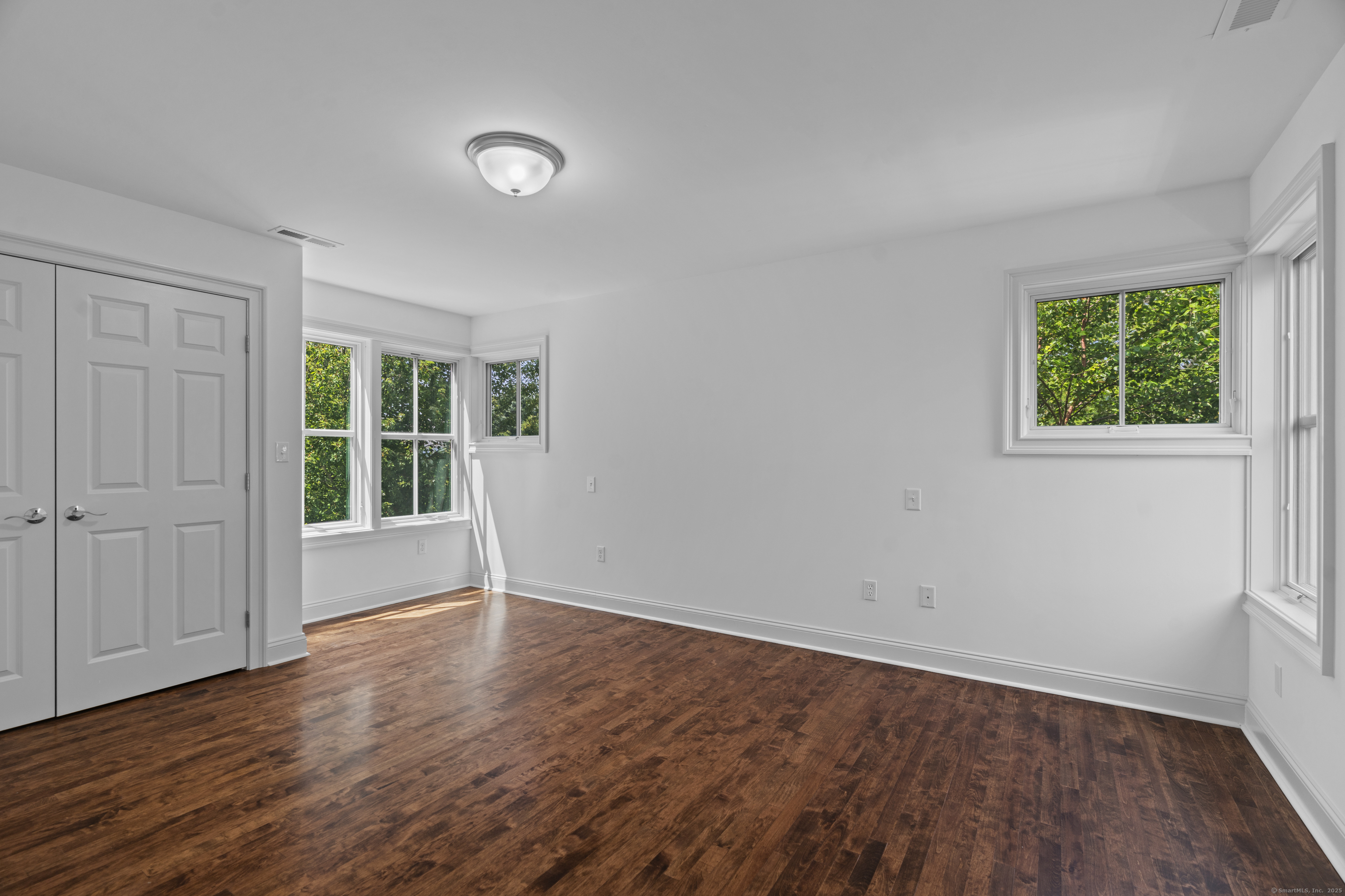64 Webster Point Road Madison, CT 06443 - Photo 28 of 38 an empty room with wooden floor and windows