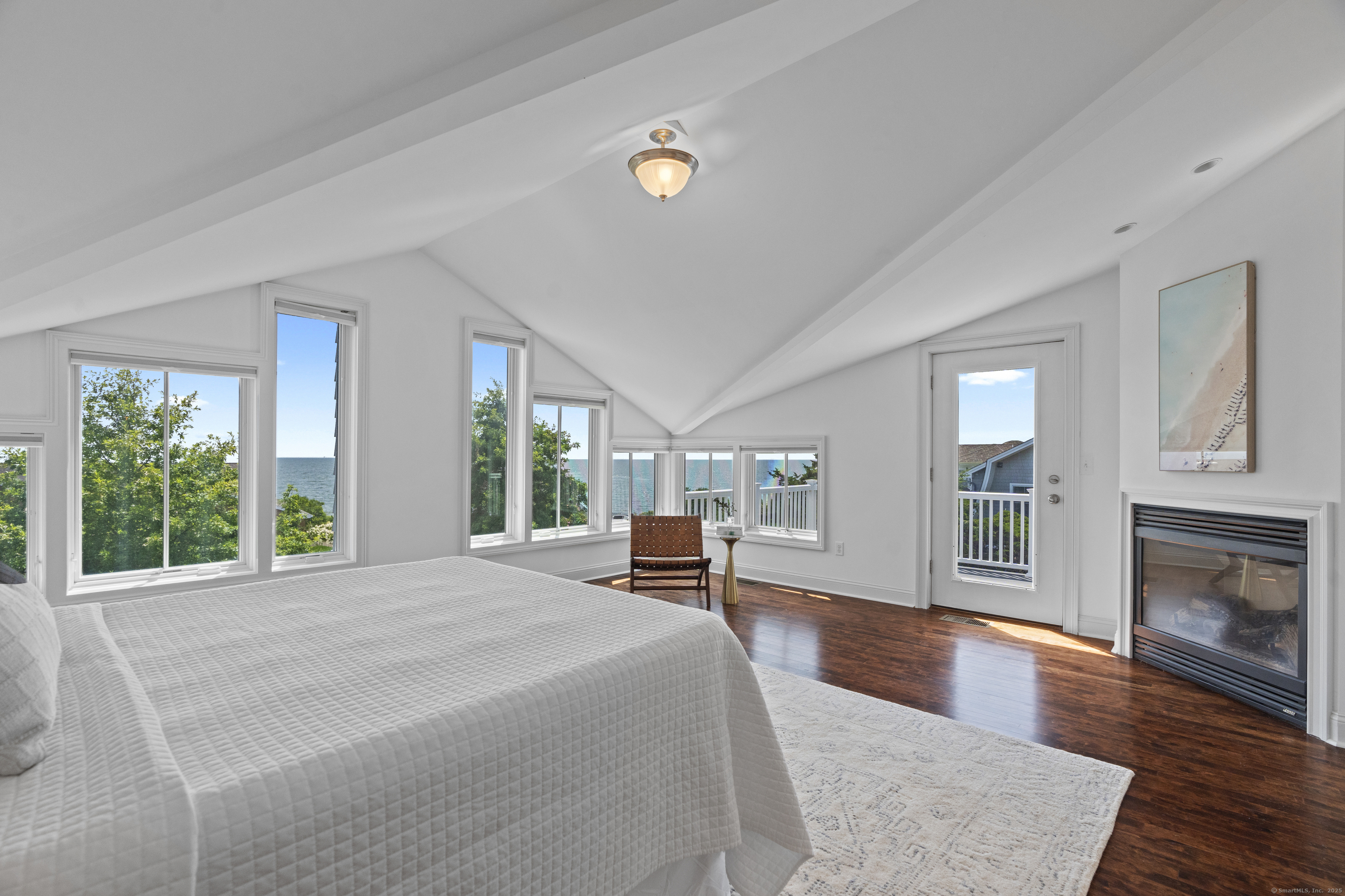 64 Webster Point Road Madison, CT 06443 - Photo 31 of 38 a bedroom with furniture and a fireplace