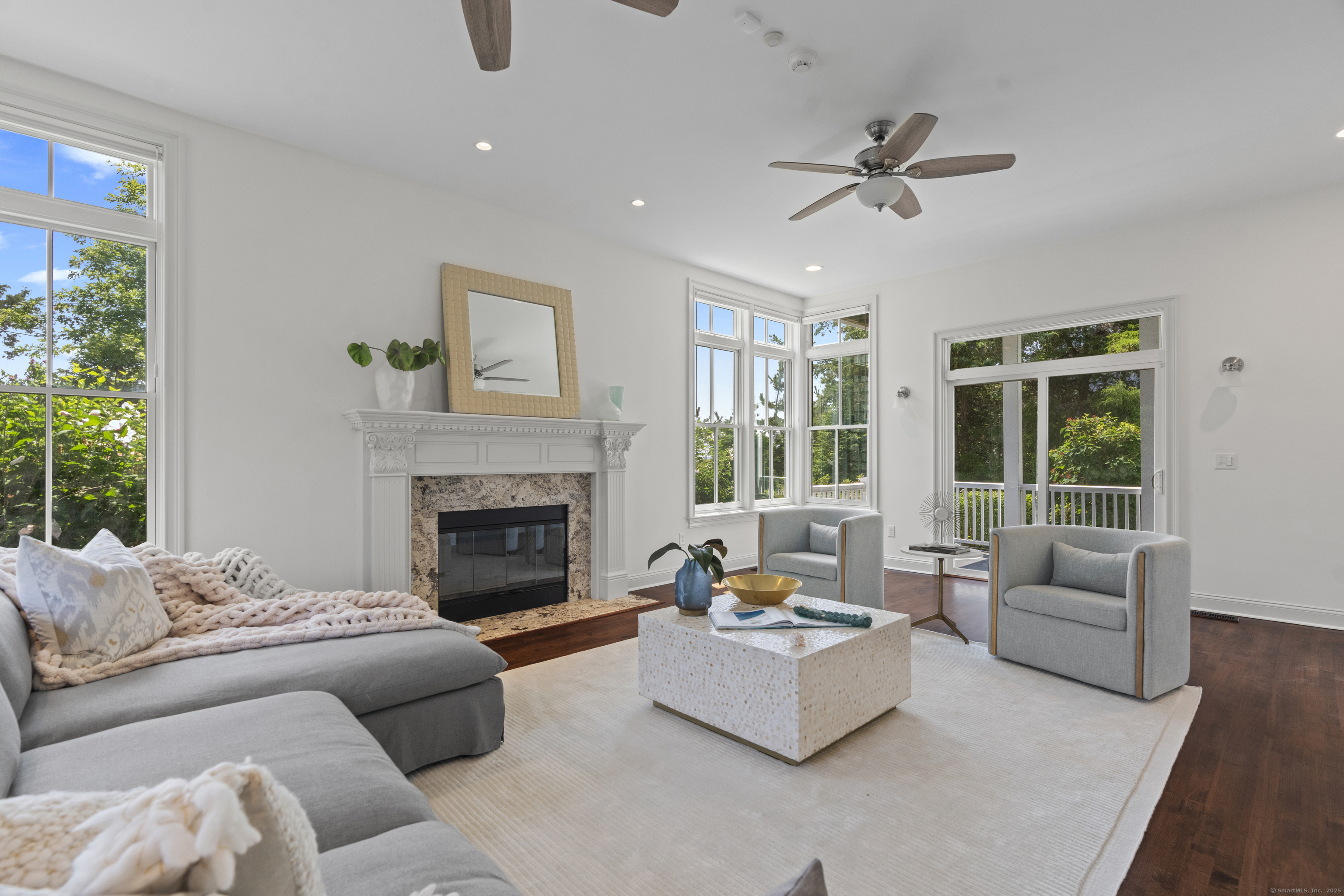 64 Webster Point Road Madison, CT 06443 - Photo 10 of 38 a living room with furniture and a fireplace
