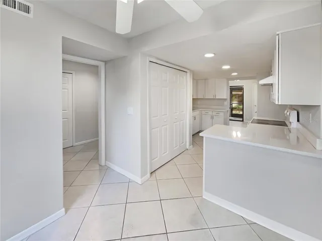 a kitchen with a sink a refrigerator and cabinets