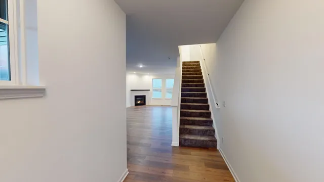 a view of entryway and hall with wooden floor