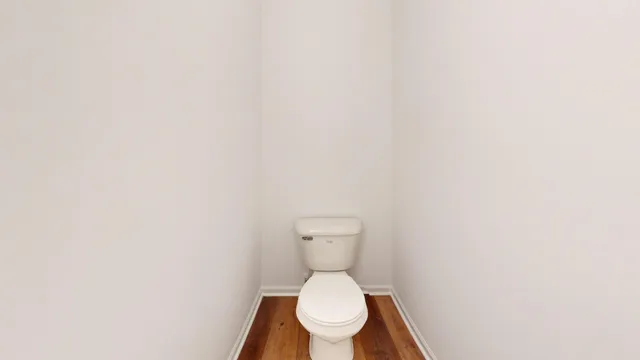 a white toilet sitting in a bathroom