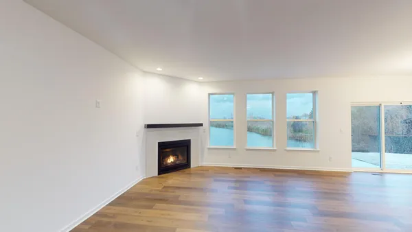 a view of an empty room with glass door and balcony