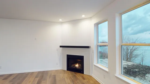 a view of an empty room with a fireplace