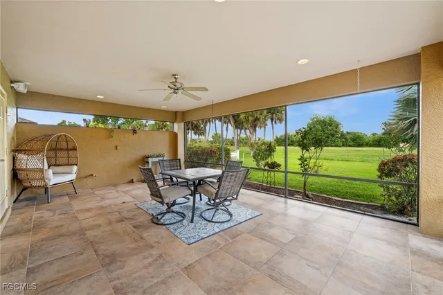 a living room with a bed furniture and a flat screen tv