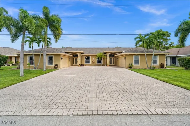 a kitchen with stainless steel appliances kitchen island granite countertop a table chairs microwave and sink