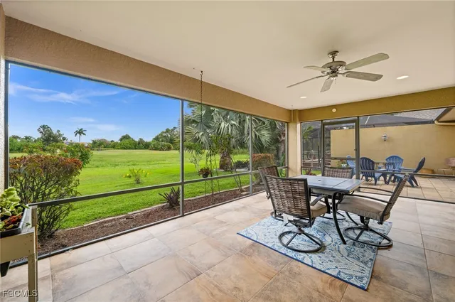 a view of a patio with a table chairs and a backyard