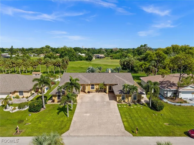 a kitchen with stainless steel appliances granite countertop a sink and a refrigerator