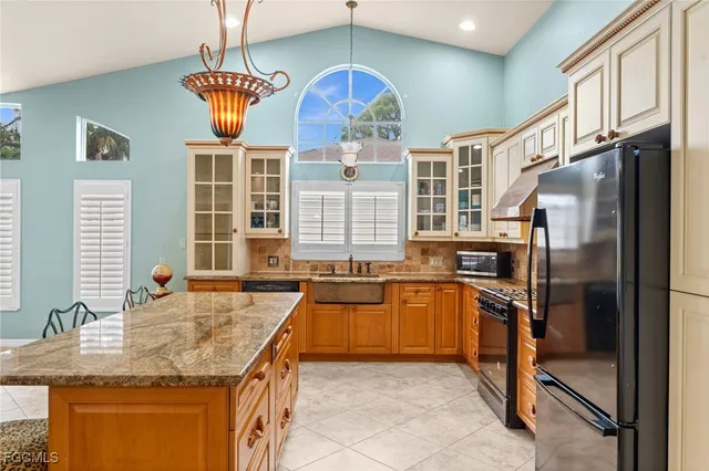 a living room with fireplace furniture and a chandelier