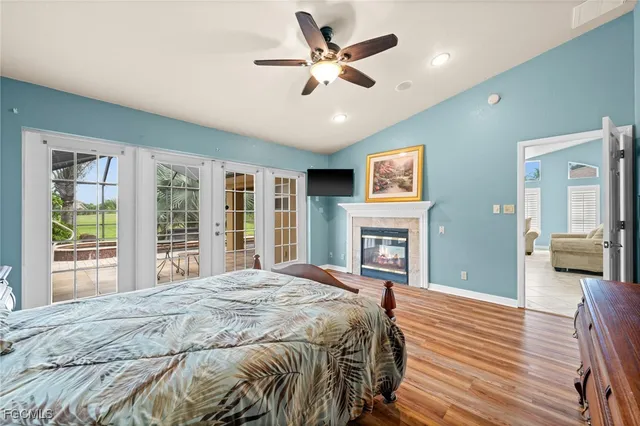 a bedroom with a bed wooden floor and window