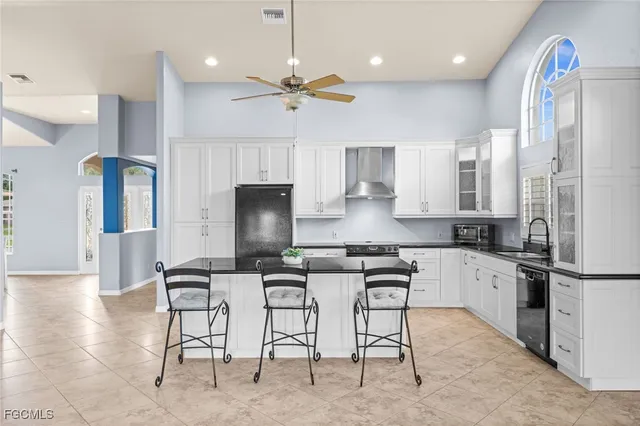 a kitchen with stainless steel appliances kitchen island granite countertop a sink and cabinets