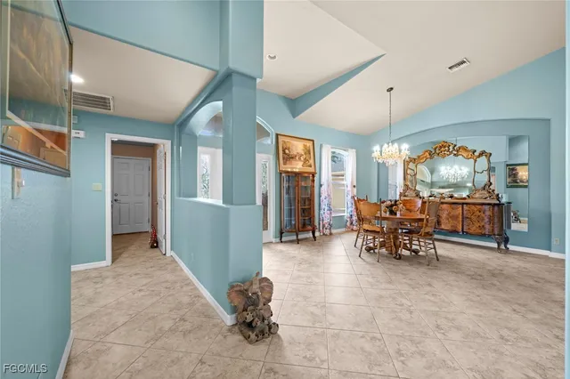 a large kitchen with stainless steel appliances granite countertop a stove and a view of living room