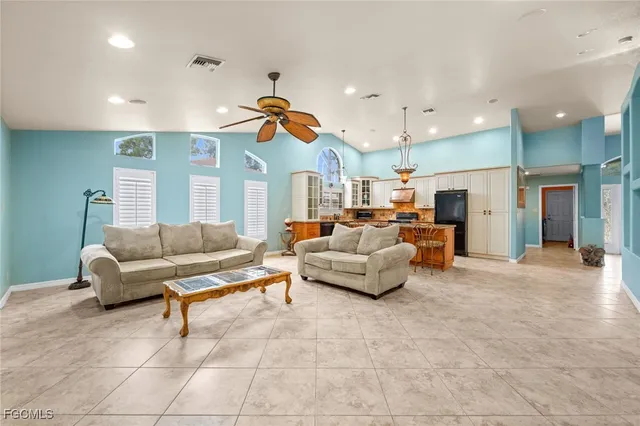 a kitchen with stainless steel appliances granite countertop a refrigerator a sink and a stove